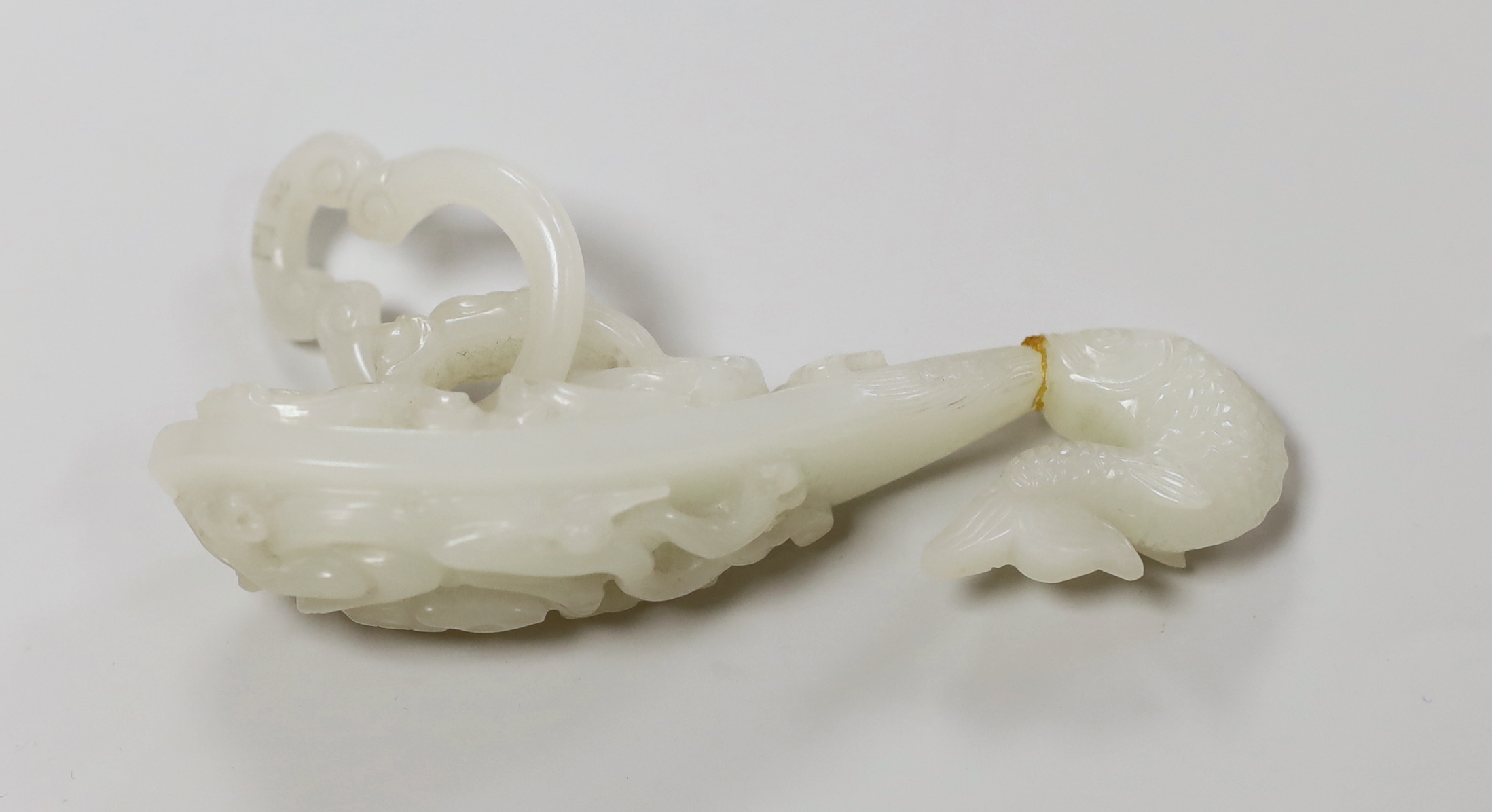 A Chinese white glass belt hook, apocryphal Qianlong marks (damaged)